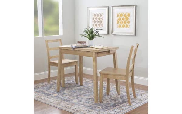Brendon 3-piece traditional gray solid wood dining set with two ladder-back chairs and a folding table. Made of rubberwood solids, MDF, plywood, steel, and paper veneer. Table folds flat for space-saving and doubles in size with hidden under-table storage for placemats or cutlery. Perfect for small kitchens or studio apartments.