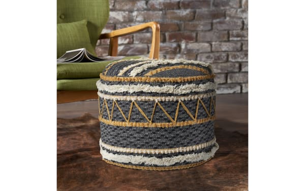 Reyna Black Pouf in black, white, and brown cotton fabric with geometric patterns and textured stripes, handcrafted contemporary round ottoman.