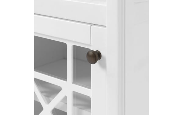 White Austin 29'' freestanding bathroom cabinet with pine solids and MDF, featuring a glass door with gridwork detail and bronze knob.