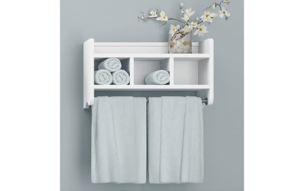 Durant White Solid Wood Bathroom Wall Shelf with Towel Bar in transitional style, made of pine solids and MDF, features three cubbies, a raised-edge top shelf, and two towel rods with light blue towels, perfect for organizing toiletries and washcloths.