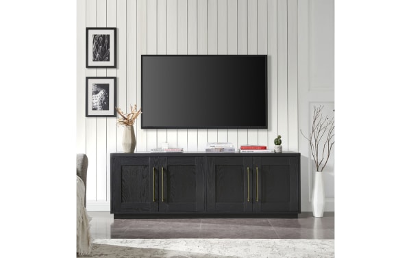 Syvia 68'' black MDF storage TV stand in transitional style with dual-level closed cabinet shelving, brass handles, and cord management openings.