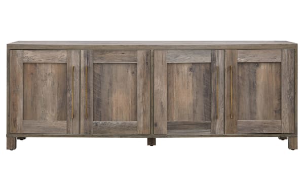 Zion 68'' Gray Storage TV Stand in transitional style with sturdy MDF frame, four cabinet doors, gold handles, and rustic gray wood finish.