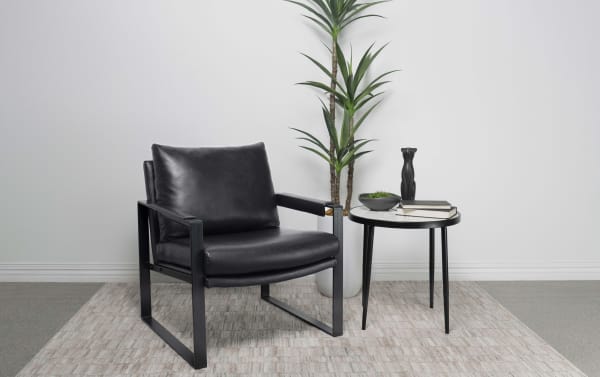 Breya Black Accent Chair with smooth black faux leather upholstery, padded seat and armrests, and gunmetal metal frame in contemporary style.