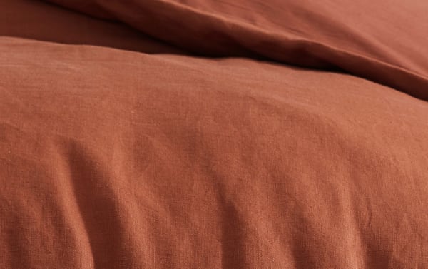 Weston Orange 4 Piece Queen Comforter Set in warm orange linen and polyester fabric, featuring a soft, transitional style with a washable cover.