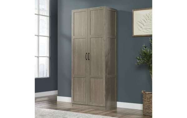Bella Gray 2 Door Storage Cabinet in rustic gray particle board and metal, featuring four adjustable shelves and black metal handles for versatile storage.