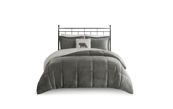 Gray velvet comforter set with sherpa lining, includes matching pillow shams and decorative bear accent pillow on black metal bed frame.