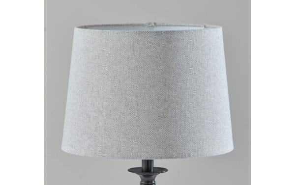 Contemporary Mirza table lamp with light gray linen fabric shade and sleek black steel spiral base, perfect for modern decor.