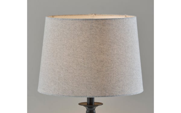 Contemporary Mirza table lamp with light gray linen fabric shade and sleek black steel base, ideal for modern home decor lighting.