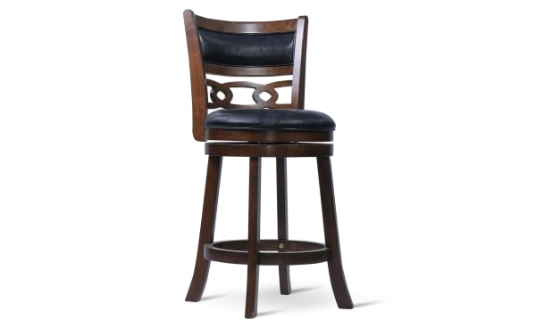 Wooden bar stool with dark brown finish, black cushioned seat and backrest, decorative back design, and swivel base.