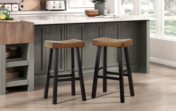 Alicia Black & Brown Rustic Solid Rubberwood Backless Bar Height Stool Set of 2 with saddle-style wooden seats and black legs, perfect for kitchen islands.
