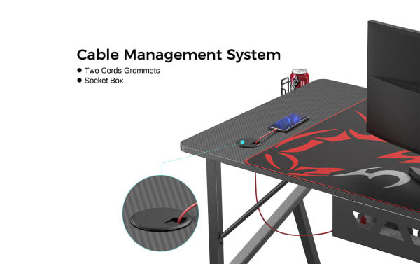 Cable Management System with two cords grommets and socket box, showing a carbon fiber textured desk with a red and black mouse pad, a smartphone connected through a grommet hole, and a can holder.