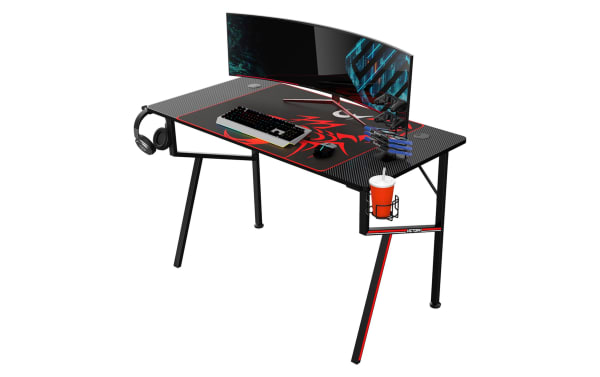 Kai Black Gaming Desk with carbon-fiber particle board surface, black powder-coated metal frame, headset hook, cup holder, gamepad rack, and USB ports.