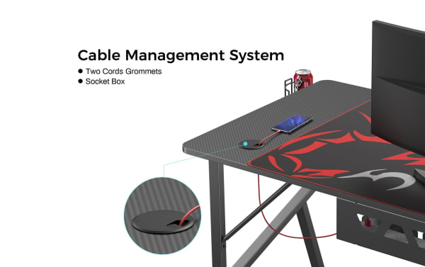Kai Black Gaming Desk cable management system with carbon-fiber particle board surface, powder-coated metal frame, dual cord grommets, and under-desk socket box.