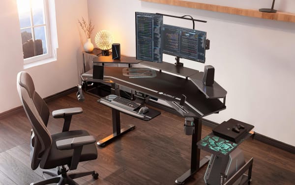 Aries 72'' Black Adjustable Gaming Desk by Eureka Ergonomic, transitional style with particle board, powder-coated metal, dual motor lift, dual monitor risers, iPad slots, cup holder, headphone hook, full-desk mouse pad, and cable management.