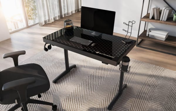 Orbit Black Glass Top Gaming Desk with tempered glass surface and powder-coated metal frame, featuring RGB lighting, cup holder, headphone hook, and controller rack. Compact, sturdy black gaming desk from Burakadesk, ideal for gaming, streaming, and workstation setups.