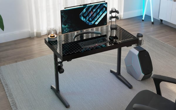 Orbit Black Glass Top Gaming Desk with black tempered glass surface and powder-coated metal frame, featuring built-in RGB lighting, headphone hook, cup holder, controller rack, and USB outlet for gaming setups.