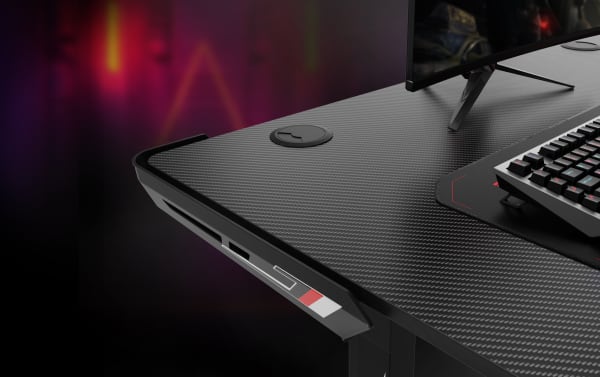 Aurora Black Adjustable Gaming Desk with carbon-fiber textured particle board surface, powder-coated metal frame, dual cable management, and built-in socket holder.