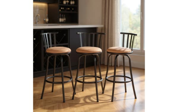 Three modern black metal bar stools with round tan cushioned seats and vertical backrests, placed on a wooden floor near a kitchen counter.
