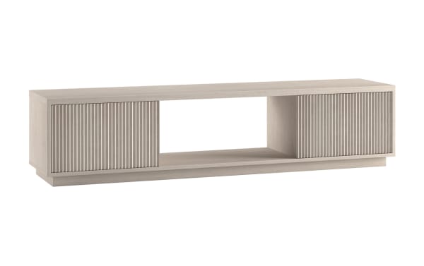 Modern low-profile TV stand in light wood finish with two vertically grooved sliding doors and open central shelf for media devices.