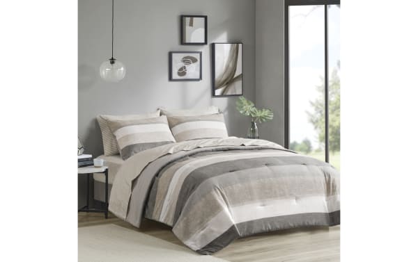 Santos King Taupe 7 Piece Striped Comforter Set in contemporary taupe, gray, light gray, and white polyester fabric, featuring wide horizontal stripes and matching pillow shams for a cozy, stylish bedroom.
