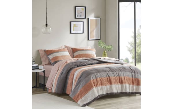 Santos Queen Terracotta 7 Piece Striped Comforter Set in orange, gray, light gray, and white polyester fabric. Contemporary style with bold horizontal stripes, includes comforter, pillow shams, and fitted sheet. Designed for cozy, stylish bedroom decor with durable, soft polyester material.