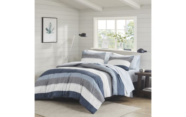 Santos Queen Blue 7 Piece Striped Comforter Set in blue, light blue, gray, light gray, and white polyester fabric with contemporary wide horizontal stripes.