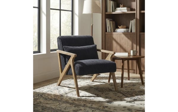 Baylor Black Accent Chair with mid-century modern design, black polyester fabric upholstery, natural wood frame, and included lumbar pillow for comfort.
