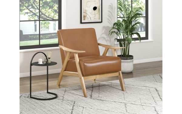 Kane Brown & Natural Faux Leather Accent Chair with mid-century modern design, brown faux leather upholstery, solid rubberwood frame, and metal legs.