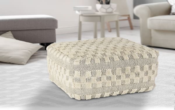 Bello Cream Pouf in cream wool upholstery with textured mid-century modern design, handcrafted accent piece for stylish living spaces.