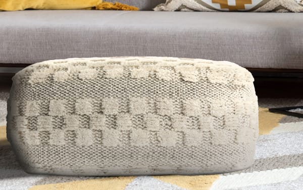 Bello Cream Pouf in cream wool with mid-century modern style, featuring textured woven pattern and soft plush accents, ideal as a stylish accent piece.