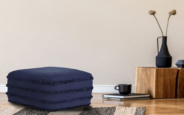 Thea Navy Pouf in contemporary style, made of navy blue cotton fabric with textured horizontal stripes, perfect for living rooms or bedrooms.