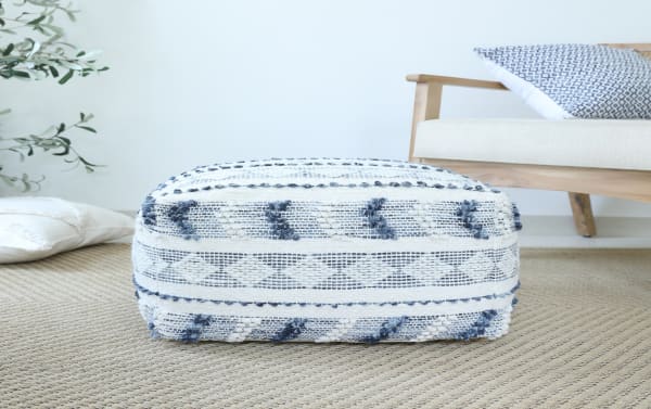 Koda Navy Pouf in navy and ivory wool and cotton blend with textured geometric patterns, perfect as a cozy transitional-style footrest or extra seat.