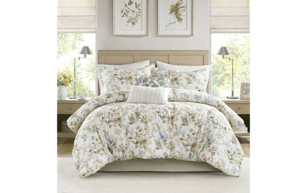 Botanical Bliss Queen Ivory 6 Piece Comforter Set with floral print in ivory, brown, green, blue. Cotton and polyester blend with dash-stitching, bartack design, and removable pillow inserts for durability and easy care. Contemporary style with oversized coverage and nature-inspired elegance.
