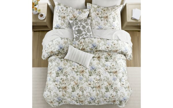 Botanical Bliss Queen Ivory 6 Piece Comforter Set with floral print in ivory, brown, green, blue. Cotton-polyester blend, contemporary style, breathable cotton, down-alternative fill, dash-stitching, oversized coverage, removable pillow inserts.