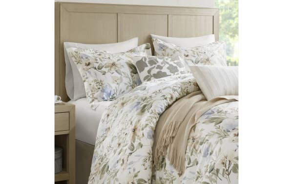 Botanical Bliss Queen Ivory 6 Piece Comforter Set with floral print in ivory, brown, green, and blue. Made of breathable cotton and polyester fabric with a contemporary style, featuring dash-stitching and bartack design for durability and cozy down-alternative fill.