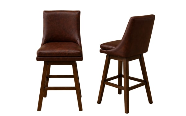 Two brown leather bar stools with cushioned seats and backs, supported by dark wooden legs with footrests, modern rustic style.