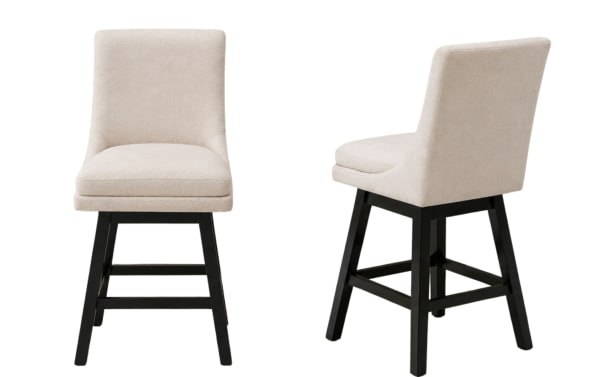 Beige upholstered swivel bar stool with cushioned seat and backrest, black wooden legs, and footrest, suitable for kitchen or bar seating.