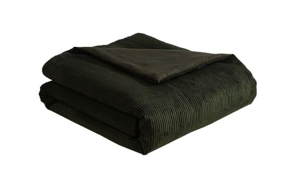 Dark green corduroy textured blanket with a smooth fabric underside, folded neatly for home bedding or cozy decor.