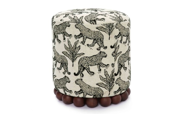 Addyson Cream Leopard Ottoman with cream and black polyester fabric, solid rubberwood orb base, contemporary style, perfect for seating or footrest.