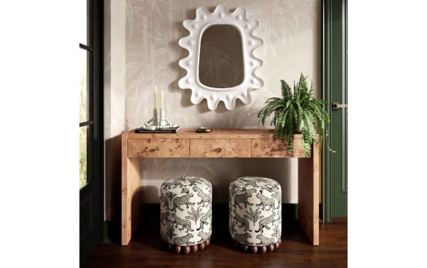 Addyson Cream Leopard Ottoman in cream and black polyester fabric with solid rubberwood orb base, offering contemporary tropical style seating or footrest.