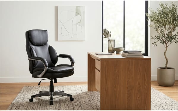 Nyx Black Adjustable Swivel Office Chair with faux leather upholstery, memory foam padding, gas lift height adjustment, tilt function, and smooth-rolling nylon casters in a contemporary home office setting.