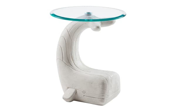 Modern side table with a white whale-shaped base made of textured material and a round clear glass top, ideal for coastal or nautical decor.