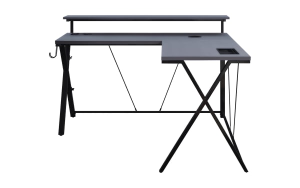 Chuck Gray L-Shaped Gaming Desk in gray MDF and black steel with built-in power outlet, dual USB ports, wireless charger, LED lights, monitor shelf, cup holder, and accessory hook.