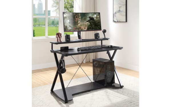Chuck Gray Gaming Desk in black painted steel and MDF with transitional style, featuring a raised monitor shelf, built-in power outlet, USB ports, wireless charging pad, accessory hook, cup holder, and lower shelf for tower PC, designed for organized gaming and home office use.