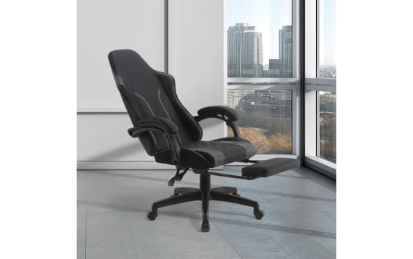Ergonomic black leather office chair with padded armrests, high backrest, and retractable footrest, ideal for comfortable desk work.