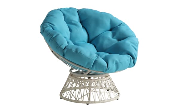Round papasan chair with a white rattan base and thick, tufted turquoise cushion, designed for comfortable seating.
