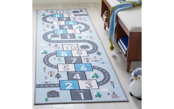 Happy Hopper 2' x 8' light blue runner rug with playful road and number block pattern in gray, white, and blue. Soft polyamide fabric, washable, slip-resistant, OEKO-TEX certified, transitional style kids area rug for safe play and learning.