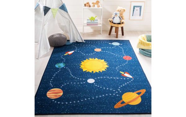 Orbit Adventure 3' x 5' blue fabric rug with playful space design, navy background, yellow sun, red and orange planets, synthetic polyamide, transitional style for kids’ rooms.