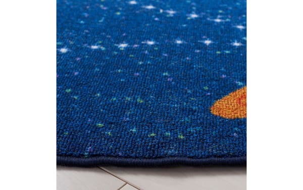 Navy blue Orbit Adventure 3' round rug with playful star pattern, durable polyamide fabric, and smooth, easy-care synthetic material for kids' rooms.