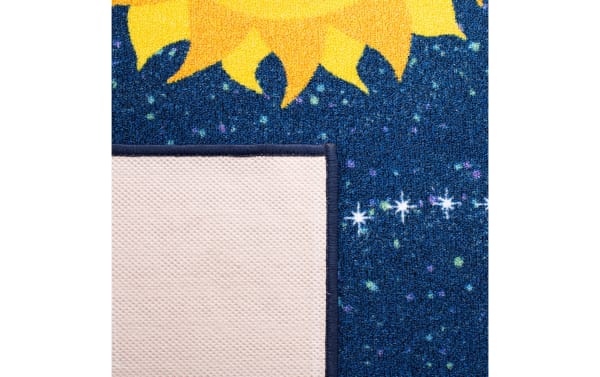 Blue and yellow children's area rug with a sunflower design and star patterns, showing the textured non-slip backing.
